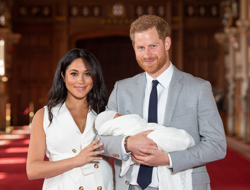 Принц Гарри, герцог Сассекский, и Меган, герцогиня Сассекская, позируют со своим новорожденным сыном Арчи Харрисоном Маунтбеттен-Виндзором во время фотосессии в Георгиевском зале Виндзорского замка 8 мая 2019 года в Виндзоре, Англия