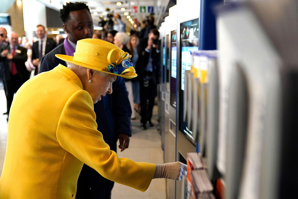 Королева Великобритании Елизавета II использует автомат по выдаче железнодорожных билетов Oyster Card во время своего визита на вокзал Паддингтон в Лондоне 17 мая 2022 года, открывая тем самым лондонский проект Crossrail &laquo;Элизабет Лайн&raquo;