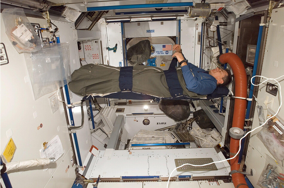 Астронавт Паоло Несполи отдыхает в своём спальном мешке на МКС