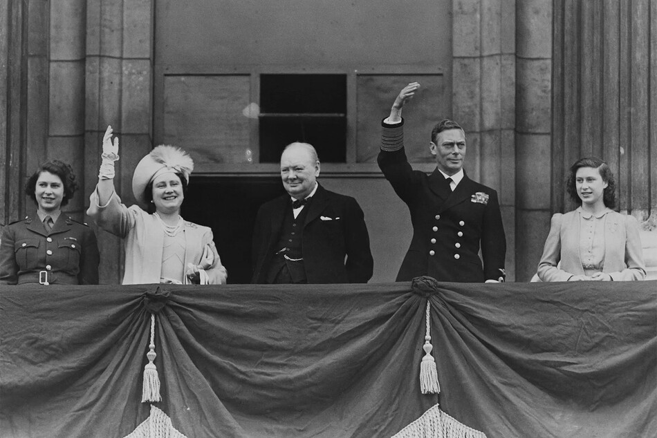 Принцесса Елизавета, королева мать, король Георг VI и Сэр Уинстон Черчилль с принцессой Маргарет приветствуют толпу с балкона Букингемского дворца 08 мая 1945 года, Лондон, Англия