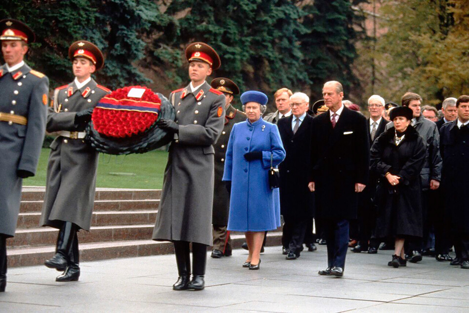 Королева Елизавета ll и принц Филипп, герцог Эдинбургский идут за солдатами, несущими венок, во время визита на могилу Неизвестного солдата 18 октября 1994 года в Москве, Россия